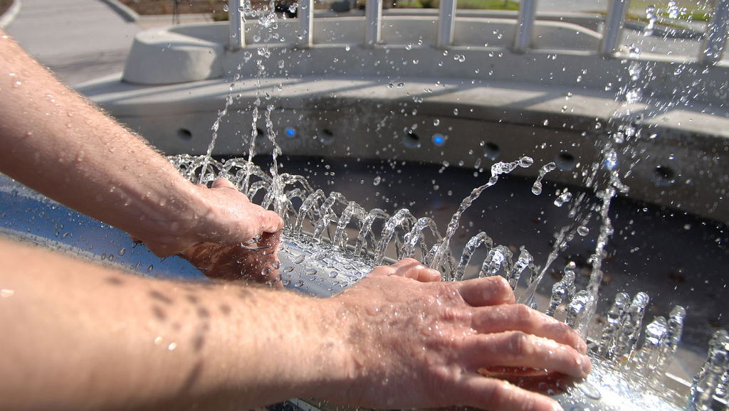 hands with a hot tub cleaning