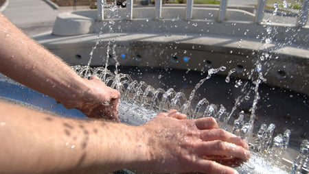 hands with a hot tub cleaning
